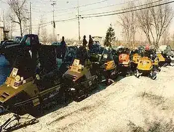 More vintage snowmobiles lined up for a ride