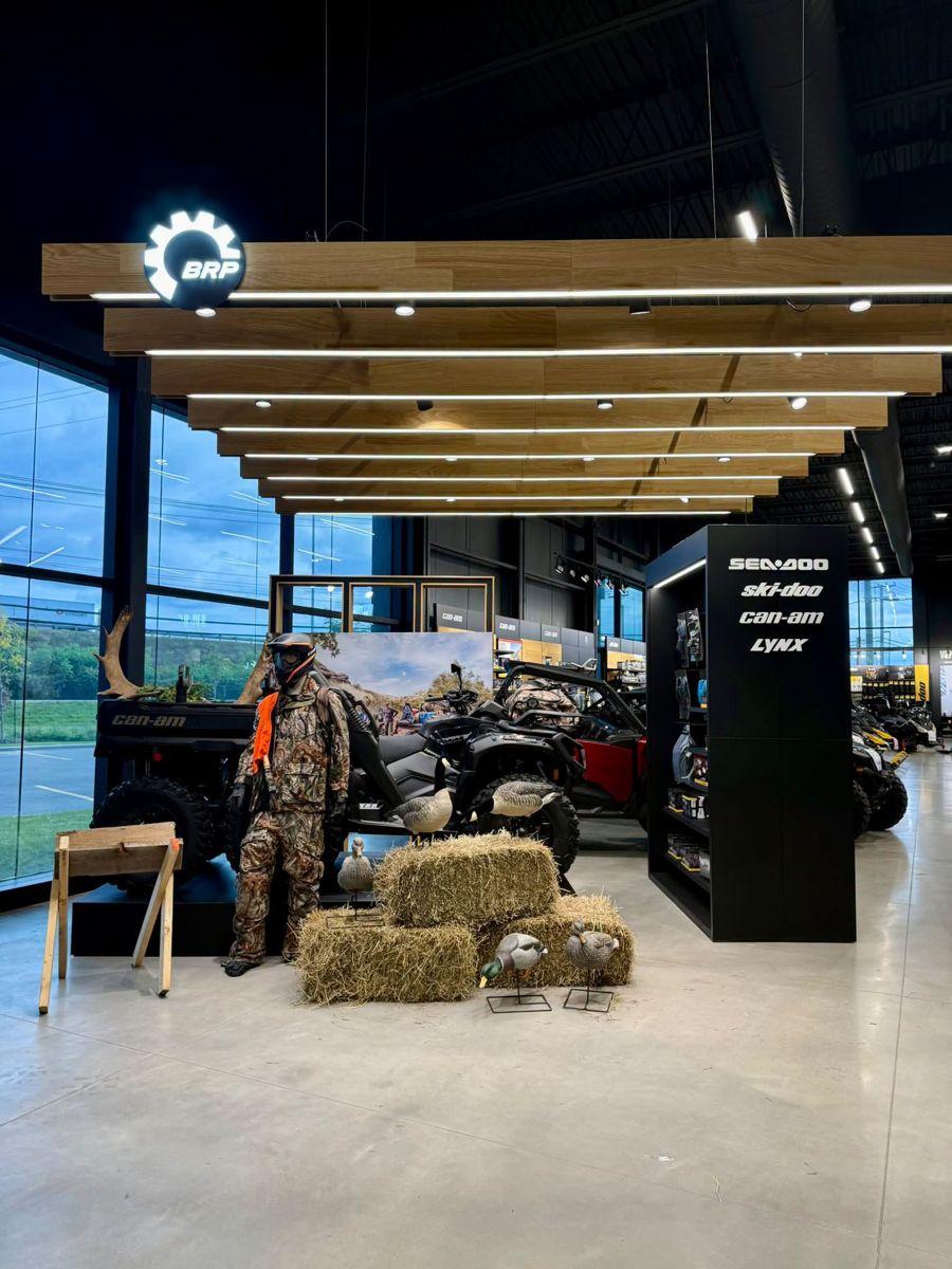 Hunting section at a Groupe Contant store: Can-Am Defender and Outlander, a mannequin in camouflage gear, decoys and hay bales